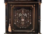 a black cabinet with a marble top and gold trimmings
