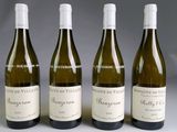 four bottles of wine are lined up on a table