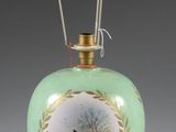 a green vase with a picture of a woman on it
