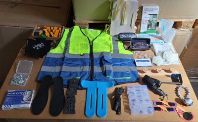 une table sur laquelle se trouvent de nombreux objets, notamment un gilet de sécurité, des gants, des ciseaux et d'autres objets
