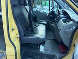 a yellow van with a black seat and a black seat belt