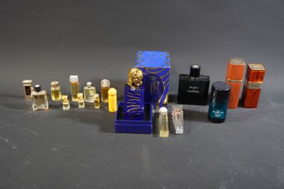 a lot of perfume bottles and a bottle of perfume on a table