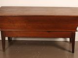 an old wooden chest sitting on top of a hard wood floor