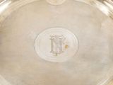 a silver tray with a monogram on it