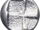 a close up of a silver coin with a cross on it