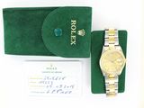 a rolex watch sitting on a green case next to a wallet