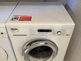 a washer and a dryer in a small bathroom