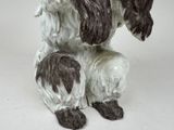 a statue of a dog that is sitting on the ground