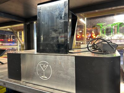 a metal box with a sign on it in a store