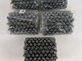 a bunch of black and white crochets in plastic bags