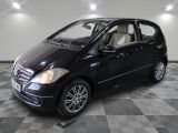 a picture of a black mercedes b - class parked on a checkered floor