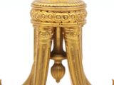 an image of a gold colored table with a clock on top of it