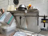 a kitchen with a stove, sink, and other items on the counter