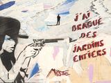 painting of a man holding a gun on a wall with graffiti on it