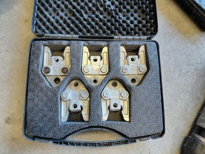 four pieces of metal in a case on a table
