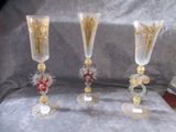three wine glasses sitting on a table next to each other