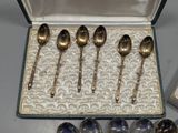 six spoons in a box with a box of silver spoons