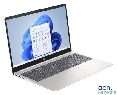 an open laptop computer sitting on top of a white surface