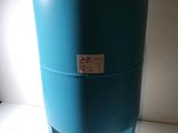 a blue water tank sitting on top of a white table