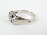 a close up of a silver ring with a diamond in the center