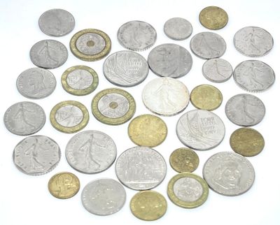 a lot of coins that are on a white surface