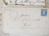 several old letters are stacked on top of each other on a table