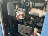 a blue machine that is sitting in a room