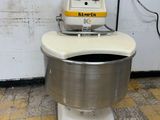a robot sitting on top of a toilet in a bathroom
