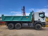 a dump truck that is parked in the dirt