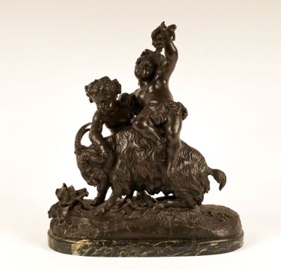 a bronze statue of a boy and a dog on a rock