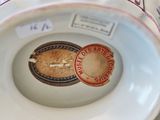 a plate with a stamp on it sitting on a table