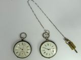 three different types of pocket watches on a white surface