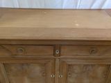 a wooden cabinet with two drawers on top of it