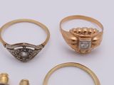 two gold rings and two silver rings with diamonds on them