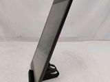 a tablet computer sitting on a stand on a white surface