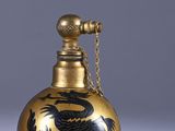 an image of a gold and black vase with a dragon on it