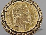 a gold coin ring with a woman ' s face on it