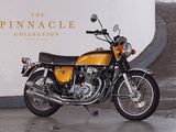 a yellow motorcycle parked in front of a white wall