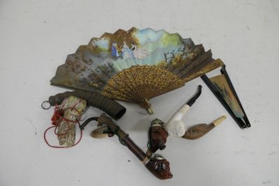 a fan, pipe, and other items on a table