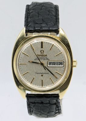 an image of a gold watch with a black leather strap