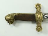 a gold and black sword on a white surface