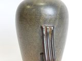 a vase that is sitting on a white surface