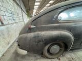 an old car that is sitting in a garage