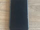 a black iphone case sitting on top of a wooden table