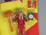 toy figure of a man in a red suit with a clock in his hand