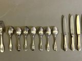 a group of forks and spoons sitting on top of a table