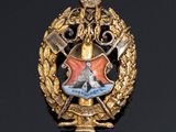 an image of a badge with a sword and shield on it