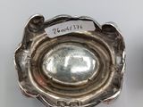 pair of silver plated candlestick holders with labels on each of them