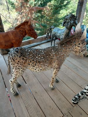 two horses that are standing on a wooden deck