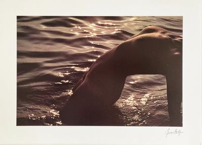 a picture of a man swimming in the water